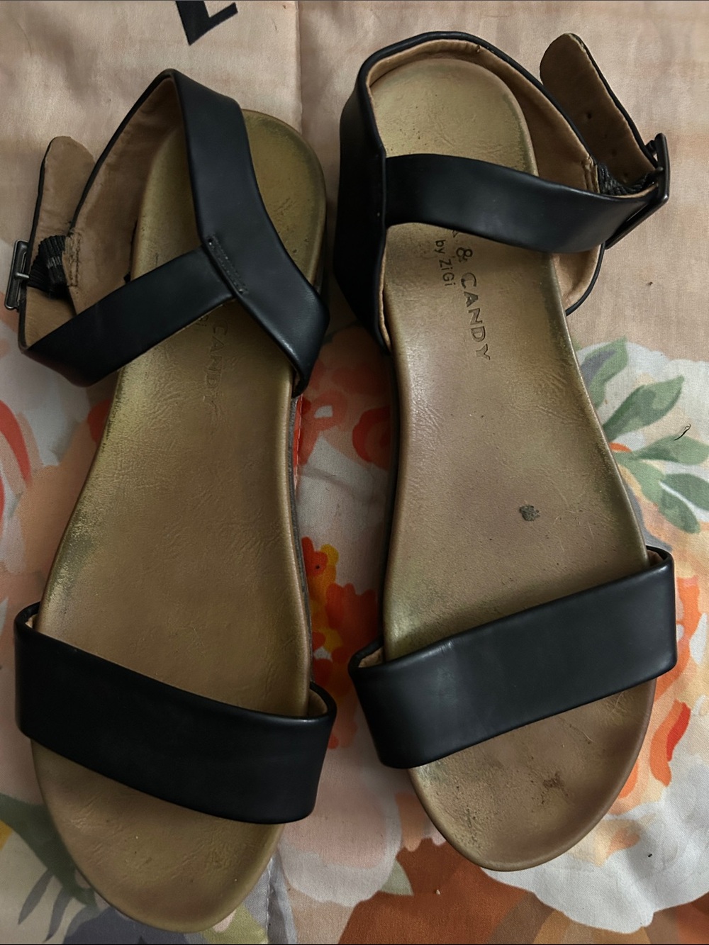 Rock Candy cBlack Ankle-Strap Flat Sandals —